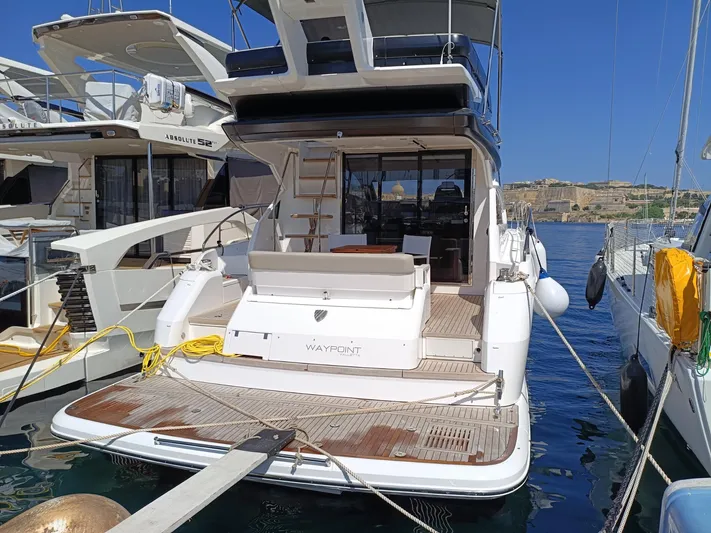  Yacht Photos Pics 2025 Fairline Squadron 50 yacht docked at marina, showcasing spacious deck and modern design.