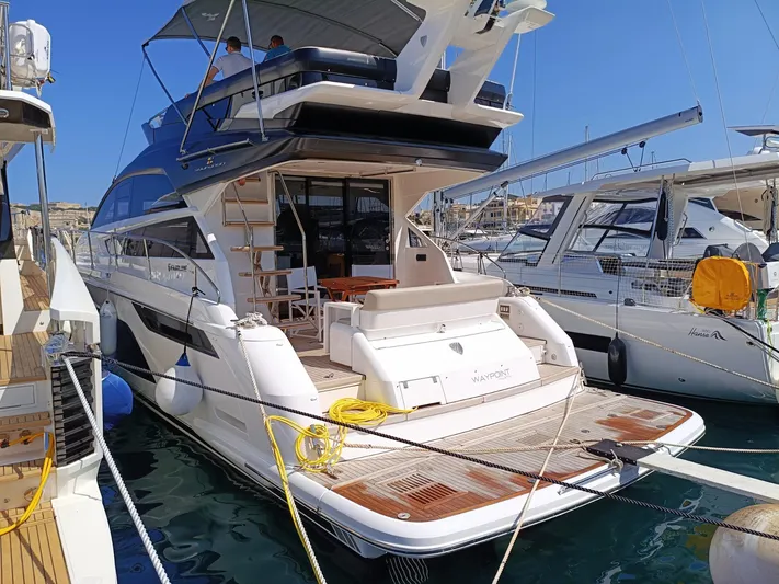  Yacht Photos Pics 2025 Fairline Squadron 50 yacht docked at marina, showcasing luxury design and spacious deck.