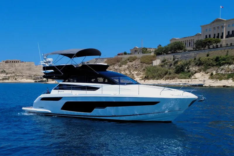  Yacht Photos Pics 2025 Fairline Squadron 50 yacht cruising near scenic coastline.