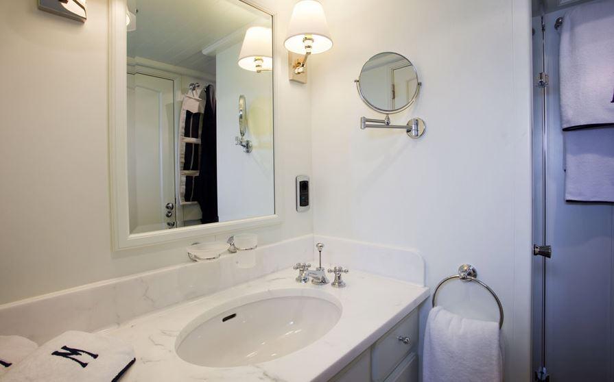 Elegant bathroom on 2005 Explorer Trawler 33m yacht with marble sink and modern fixtures.
