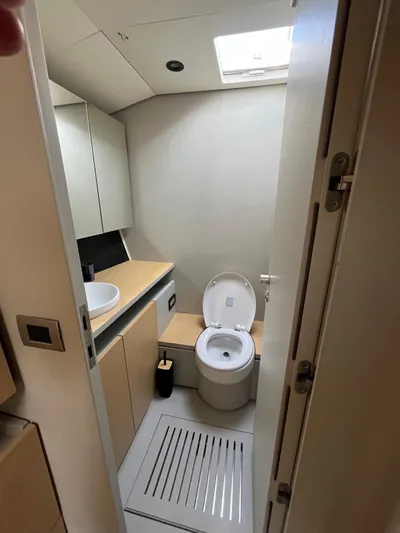  Yacht Photos Pics Bathroom interior of 2004 Vismara V78 yacht, featuring modern fixtures and skylight.