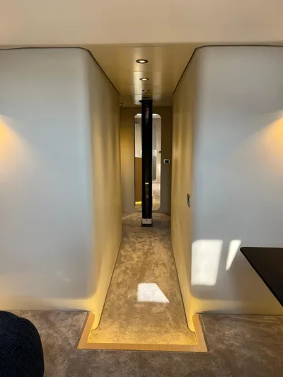  Yacht Photos Pics Hallway interior of 2004 Vismara V78 yacht with modern lighting and carpeted floor.