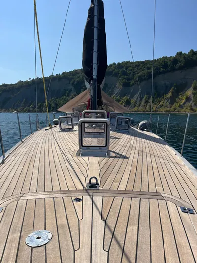  Yacht Photos Pics Vismara V78 yacht deck with wooden finish, sailing near cliffs, 2004 model.