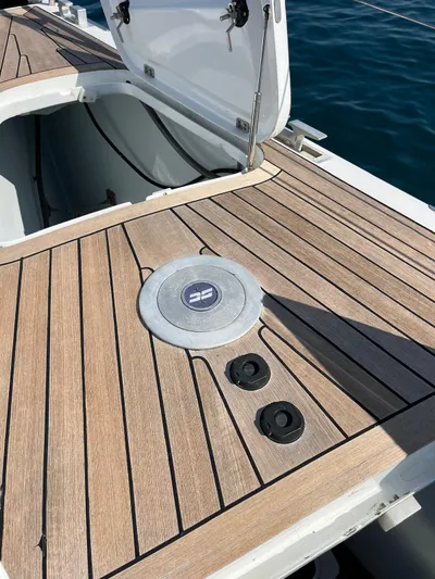  Yacht Photos Pics Teak deck of 2004 Vismara V78 yacht with open hatch, on calm water.