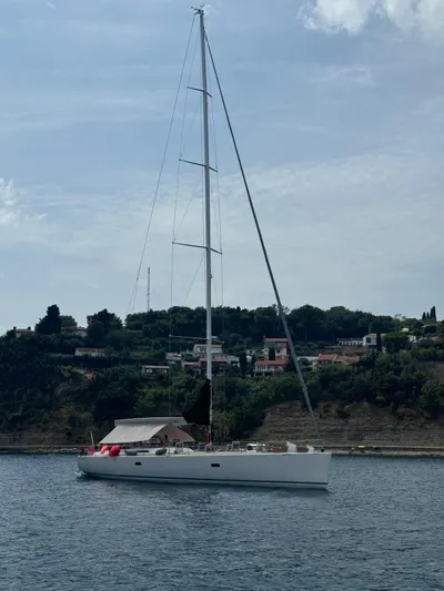  Yacht Photos Pics Sleek 2004 Vismara V78 yacht sailing near a scenic coastline.