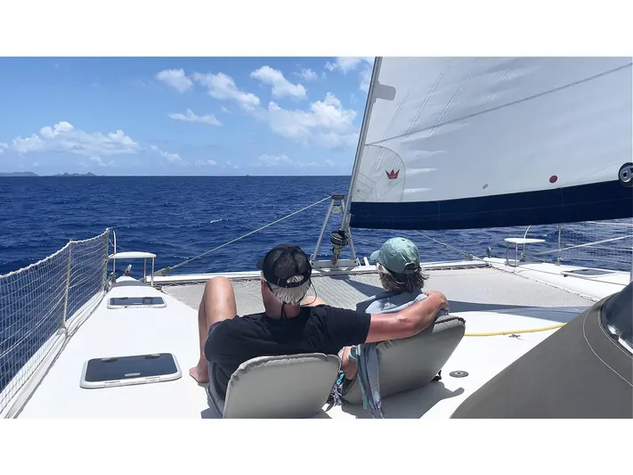  Yacht Photos Pics Couple relaxing on a 2006 Fountaine Pajot Bahia 46 catamaran sailing in the ocean.