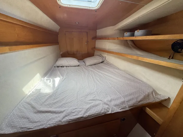  Yacht Photos Pics Cozy cabin interior of 2006 Fountaine Pajot Bahia 46 with bed and shelves.