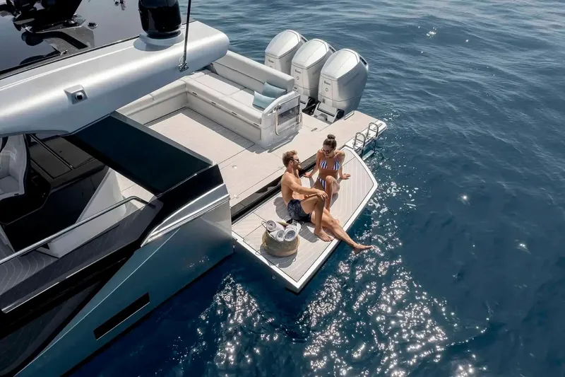 Extra II Yacht Photos Pics Couple relaxing on Azimut Verve 48 yacht, 2025 model, enjoying sunny day at sea.