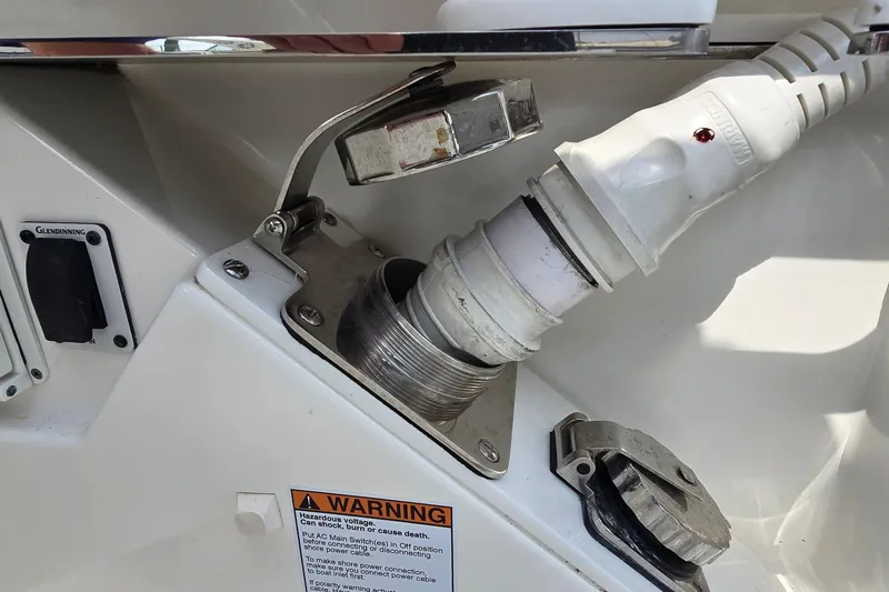 Princess Gia Yacht Photos Pics Boat power connection on a 2021 Tiara Sport 43 LS, featuring a warning label.