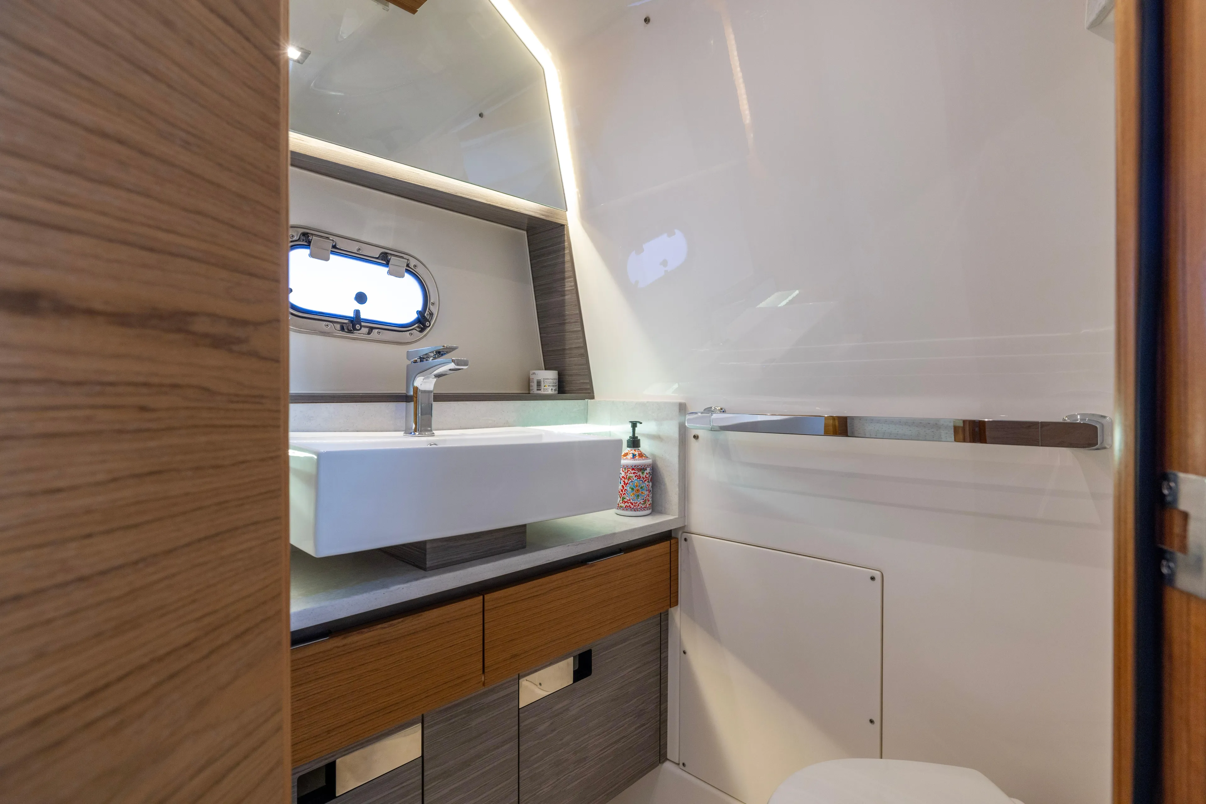 Princess Gia Yacht Photos Pics Luxurious bathroom interior of 2021 Tiara Yachts 43 LS with modern sink and porthole window.
