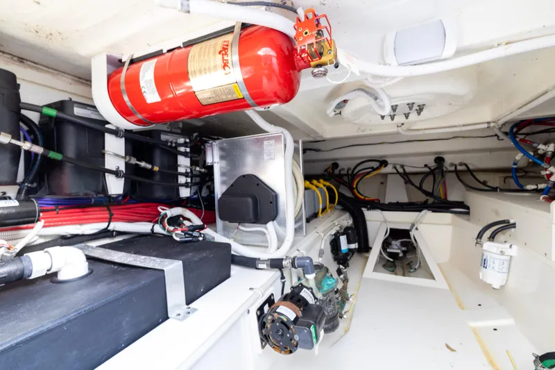 Princess Gia Yacht Photos Pics Engine room of 2021 Tiara Yachts 43 LS, featuring fire extinguisher and wiring systems.