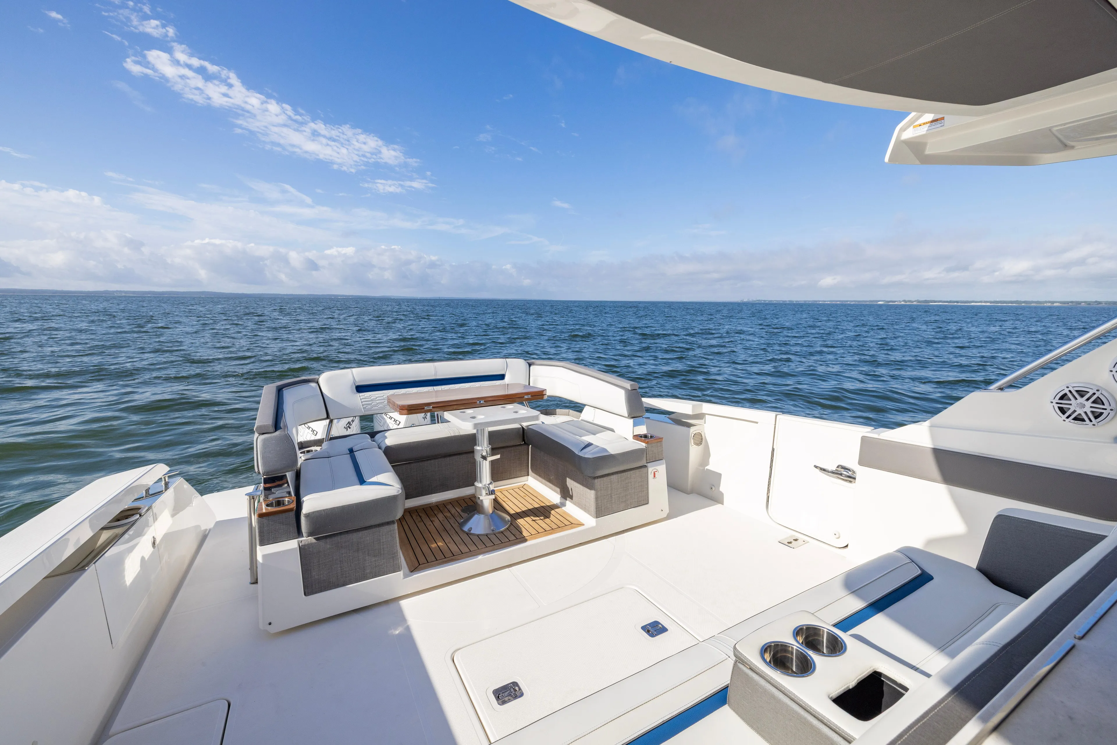 Princess Gia Yacht Photos Pics Luxurious 2021 Tiara Yachts 43 LS with elegant seating, ocean view, and sunny skies.