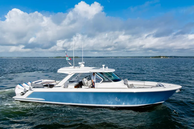 Princess Gia Yacht Photos Pics 2021 Tiara Yachts 43 LS cruising on open water under a blue sky.