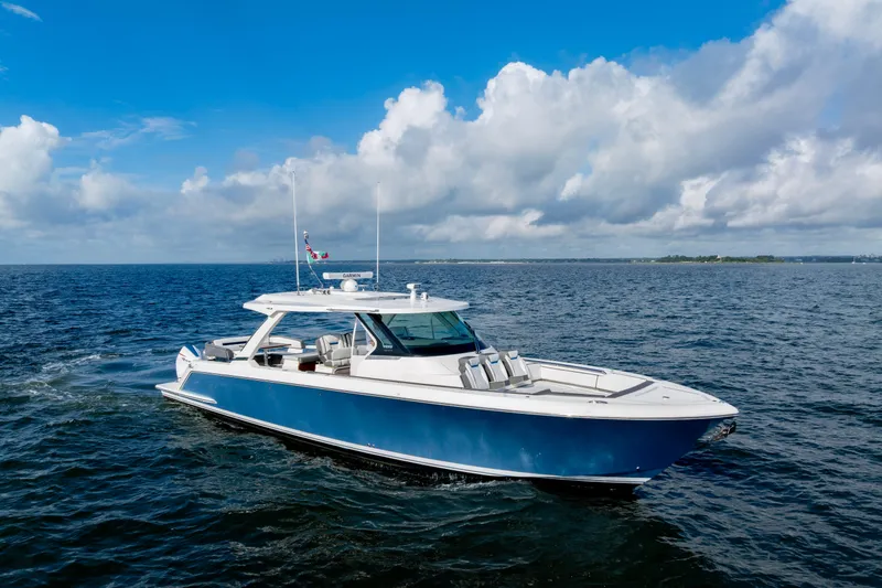 Princess Gia Yacht Photos Pics 2021 Tiara Yachts 43 LS cruising on open water under a partly cloudy sky.