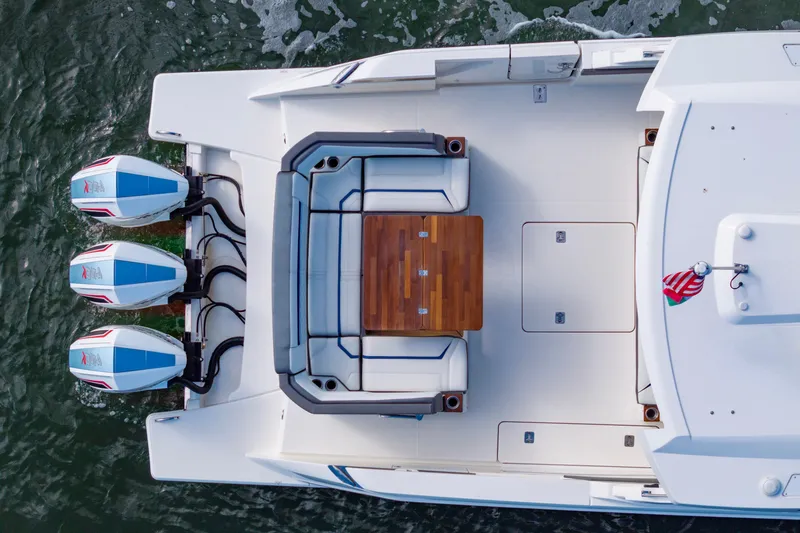 Princess Gia Yacht Photos Pics Top view of 2021 Tiara Yachts 43 LS with triple outboard engines and seating area.
