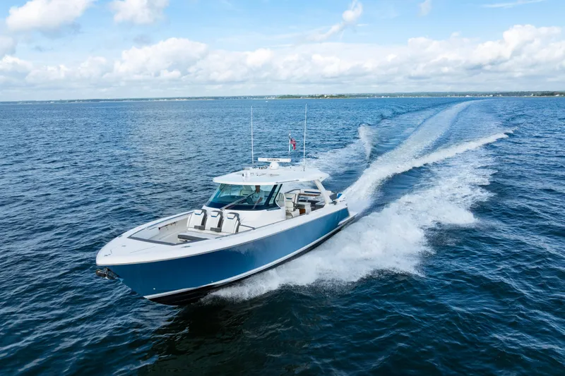 Princess Gia Yacht Photos Pics 2021 Tiara Yachts 43 LS cruising on open water under a clear sky.