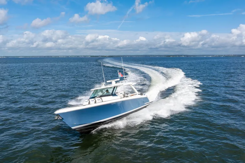 Princess Gia Yacht Photos Pics 2021 Tiara Yachts 43 LS cruising on open water under a clear blue sky.