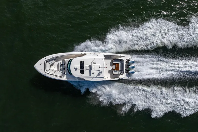 Princess Gia Yacht Photos Pics Aerial view of 2021 Tiara Yachts 43 LS speeding on water, leaving a wake.