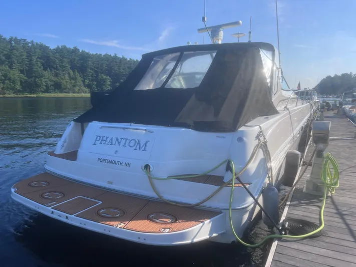 Phantom Yacht Photos Pics 2000 Sea Ray 460 Sundancer docked, rear view with black canopy, labeled "Phantom."