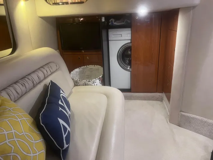 Phantom Yacht Photos Pics Interior of 2000 Sea Ray 460 Sundancer with sofa, pillows, and washing machine.