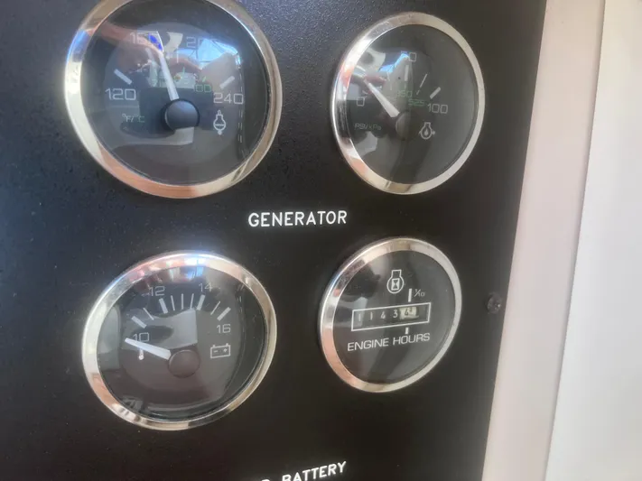 Phantom Yacht Photos Pics Close-up of Sea Ray 460 Sundancer 2000 generator gauges and engine hours display.