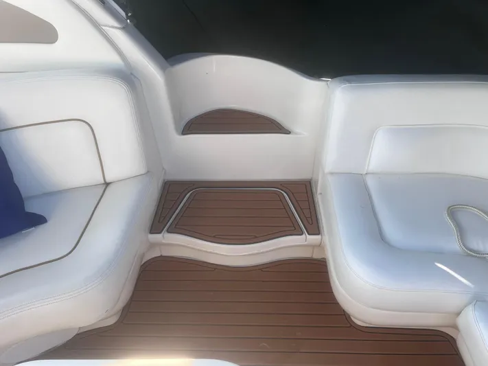 Phantom Yacht Photos Pics Interior seating of 2000 Sea Ray 460 Sundancer with white cushions and wooden flooring.