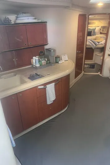 Phantom Yacht Photos Pics 2000 Sea Ray 460 Sundancer interior with kitchenette and cozy cabin view.