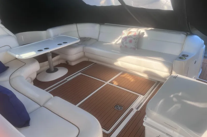 Phantom Yacht Photos Pics Luxurious interior of 2000 Sea Ray 460 Sundancer with white seating and wooden flooring.