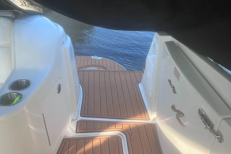 Phantom Yacht Photos Pics Sea Ray 460 Sundancer 2000 boat deck with wood finish, docked by the water.