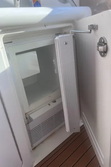 Phantom Yacht Photos Pics Open refrigerator on 2000 Sea Ray 460 Sundancer yacht, showing interior and door.