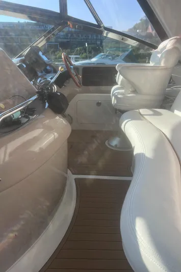 Phantom Yacht Photos Pics Interior view of 2000 Sea Ray 460 Sundancer yacht cockpit with white seating and controls.
