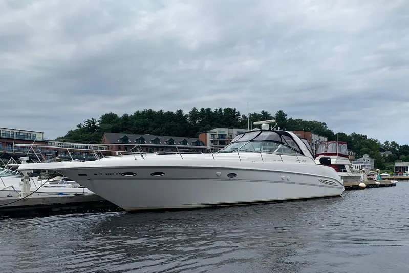 Phantom Yacht Photos Pics 2000 Sea Ray 460 Sundancer yacht docked in a marina under cloudy skies.