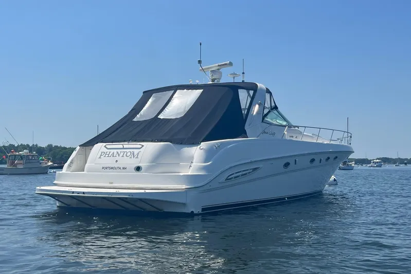 Phantom Yacht Photos Pics 2000 Sea Ray 460 Sundancer yacht on calm water, rear view.