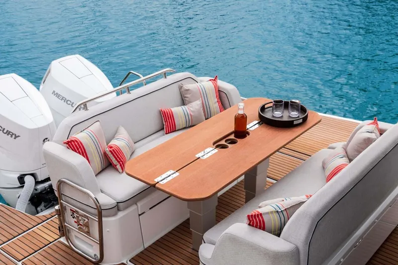  Yacht Photos Pics Manufacturer Provided Image: Luxury seating area on 2025 Beneteau Gran Turismo 35 yacht with table and cushions.