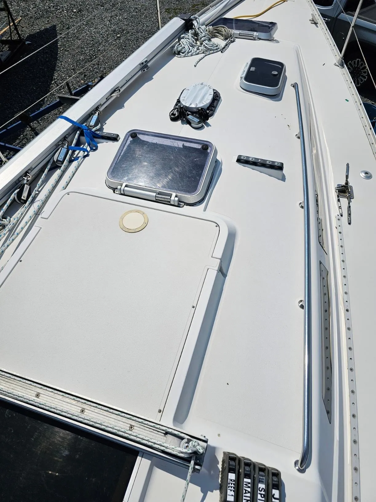 1987 CS 30 sailboat deck with hatches, ropes, and fittings.