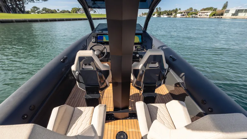 New 2025 Skipper 38 Twin 500 Yacht Photos Pics Interior view of 2025 Skipper 38 boat with modern seating and controls on the water.