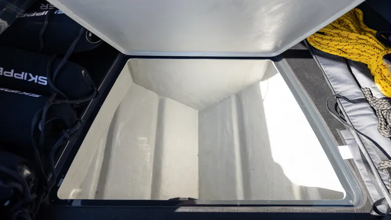 New 2025 Skipper 38 Twin 500 Yacht Photos Pics Open storage compartment on Skipper 38 boat, 2025 model, with visible ropes and equipment.