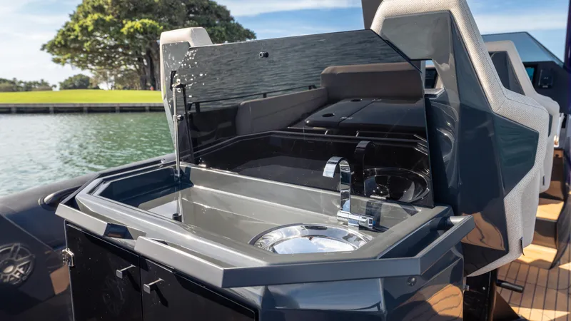 New 2025 Skipper 38 Twin 500 Yacht Photos Pics 2025 Skipper 38 boat with sleek onboard sink and faucet, docked by a scenic waterfront.