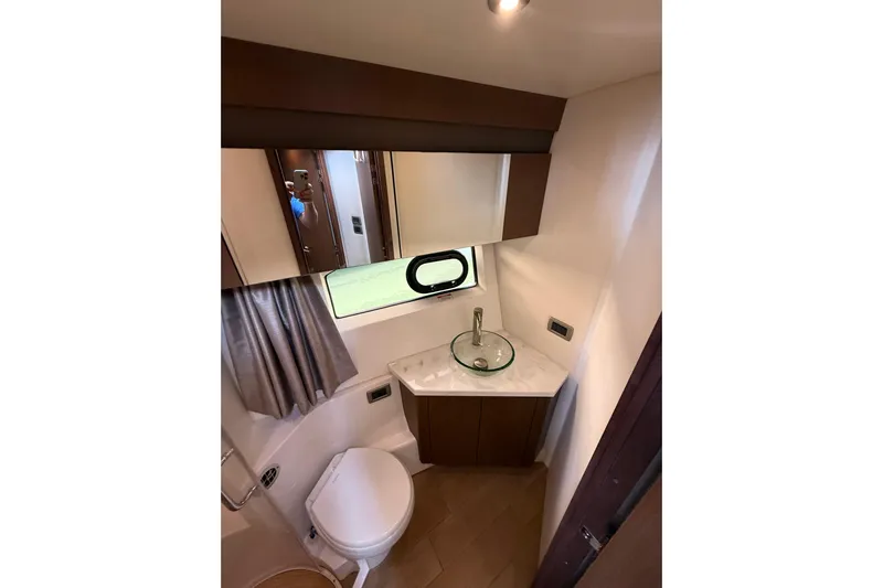 Tea Time III Yacht Photos Pics 2018 Sea Ray Fly 400 yacht bathroom with modern sink, toilet, and window.