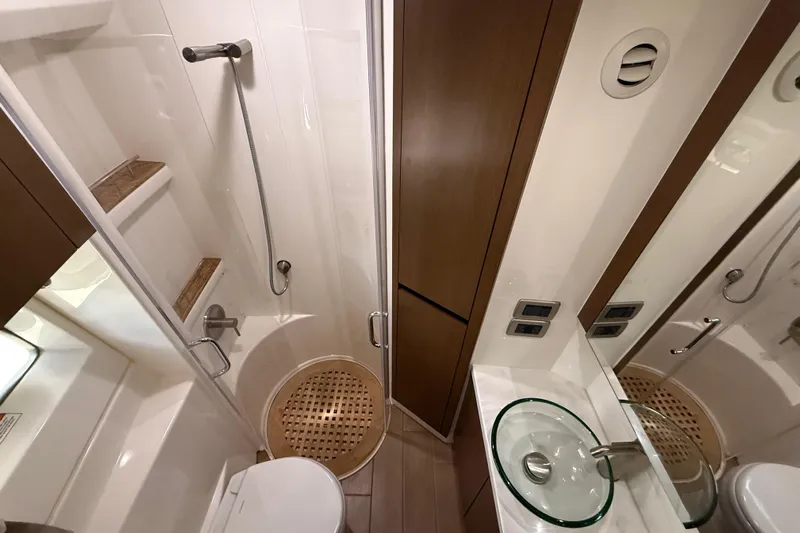 Tea Time III Yacht Photos Pics Luxurious bathroom in 2018 Sea Ray Fly 400 yacht with modern fixtures and glass sink.