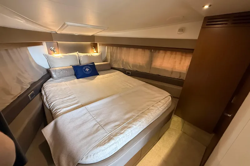 Tea Time III Yacht Photos Pics Luxurious bedroom interior of 2018 Sea Ray Fly 400 yacht with cozy bedding.