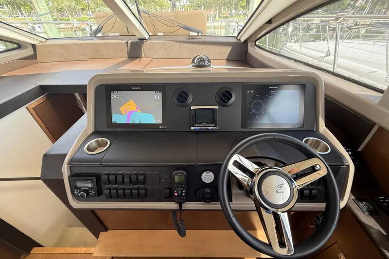 Tea Time III Yacht Photos Pics 2018 Sea Ray Fly 400 helm with navigation screens and steering wheel.
