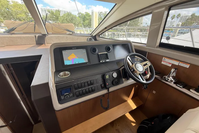 Tea Time III Yacht Photos Pics 2018 Sea Ray Fly 400 helm with navigation screens and steering wheel.