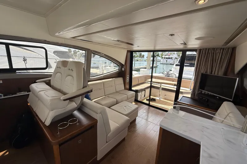 Tea Time III Yacht Photos Pics Luxurious interior of 2018 Sea Ray Fly 400 yacht with elegant seating and marina view.