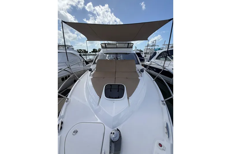 Tea Time III Yacht Photos Pics 2018 Sea Ray Fly 400 yacht with sunshade, docked under a partly cloudy sky.