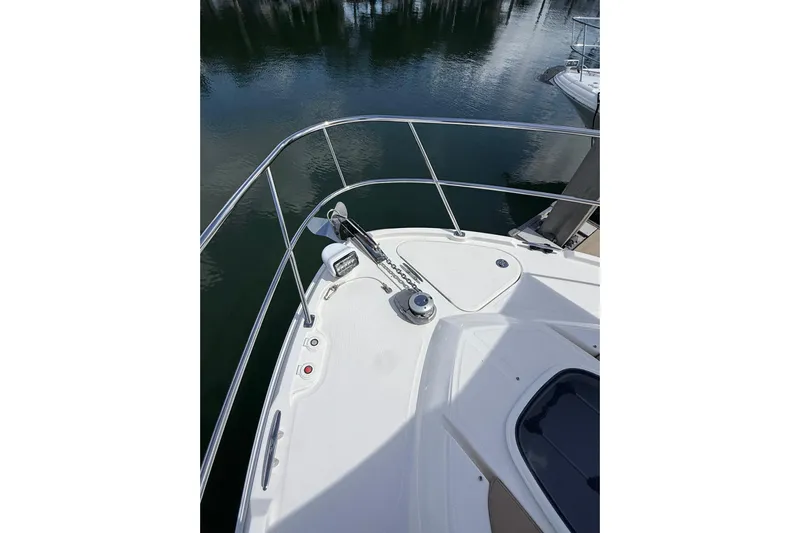 Tea Time III Yacht Photos Pics 2018 Sea Ray Fly 400 yacht bow with railing and anchor, docked on calm water.