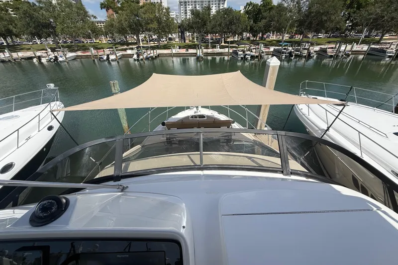 Tea Time III Yacht Photos Pics 2018 Sea Ray Fly 400 yacht docked in a marina with sunshade canopy.