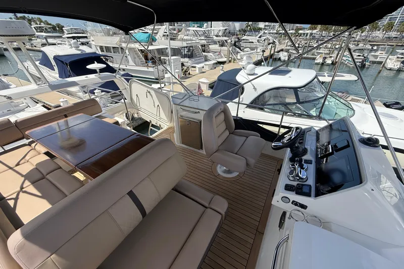 Tea Time III Yacht Photos Pics Flybridge of 2018 Sea Ray Fly 400 yacht with luxurious seating and helm, docked at marina.