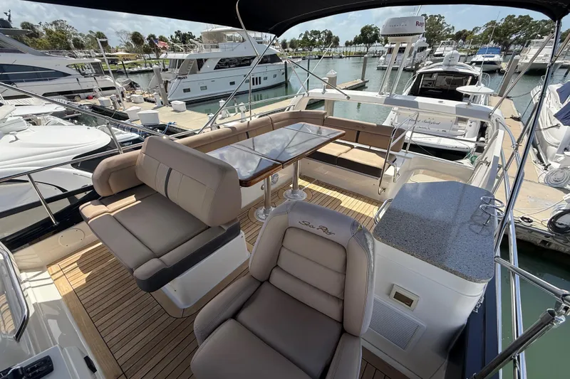 Tea Time III Yacht Photos Pics 2018 Sea Ray Fly 400 yacht interior with seating and table at marina.