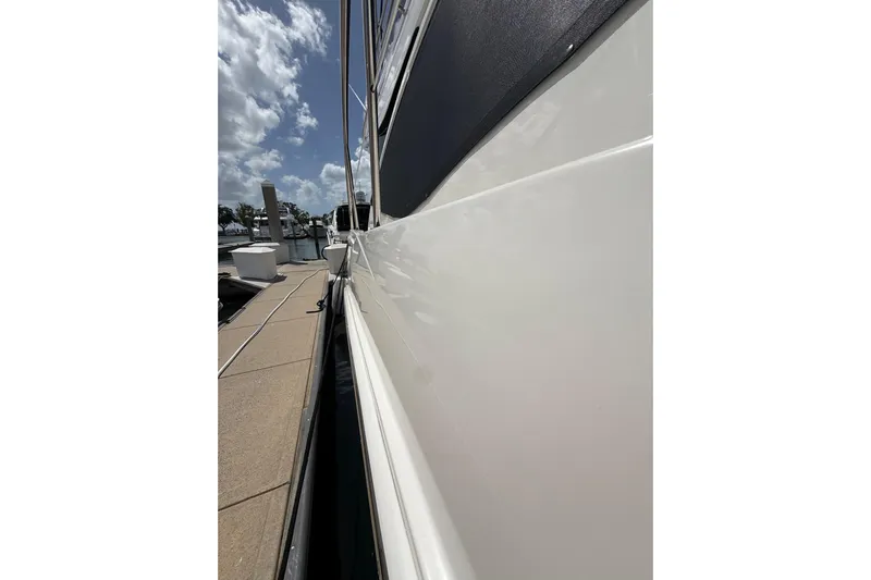 Tea Time III Yacht Photos Pics Side view of 2018 Sea Ray Fly 400 yacht docked under a partly cloudy sky.